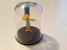 Tiny Figurine in Plastic Dome